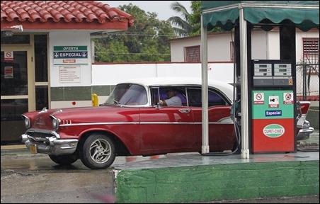 A Chevrolet 1957 Belair car is driven out of a gas station after refueling in Havana.