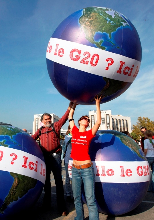 Anti G20 demonstrators hold the planet above their heads as they take part in a protest march against globalisation.