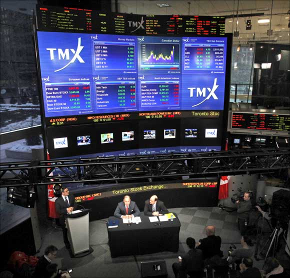 London Stock Exchange CEO Xavier Rolet (L) and TMX Group CEO Tom Kloet speak to the media.