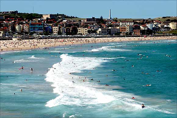 Thousands of beach goers enjoy the sun, sea and sand on Bondi Beach in Sydney.