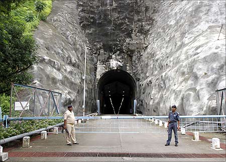 Security personnel stand guard outside the 1450 MW underground riverbed power project at the Sardar Sarovar dam in Kavadia.