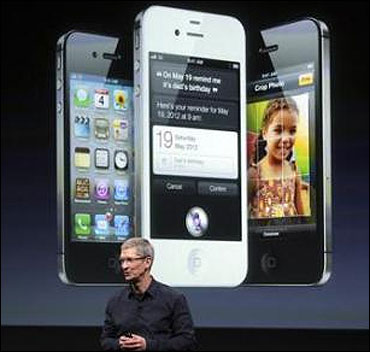 Apple CEO Tim Cook speaks in front of an image of an iPhone 4S at Apple headquarters in Cupertino, California