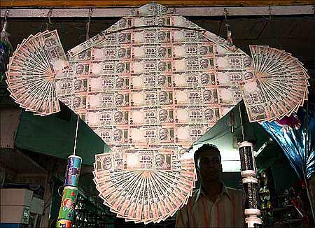 Indian rupee noted in the shape of a kite.