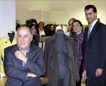 Spain's Princess Letizia and Crown Prince Felipe (R) stand next to chairman of Spanish global fashion group Inditex, Amancio Ortega (L).
