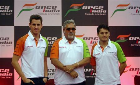 Force India's Formula One team chairman Vijay Mallya (C) poses with drivers Giancarlo Fisichella (R) of Italy and Adrian Sutil of Germany after a news conference in Mumbai March 22, 2009