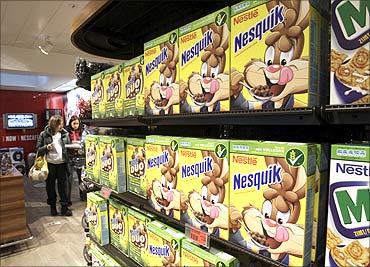 A woman walks past a food display at the company supermarket at the Nestle headquarters in Vevey.