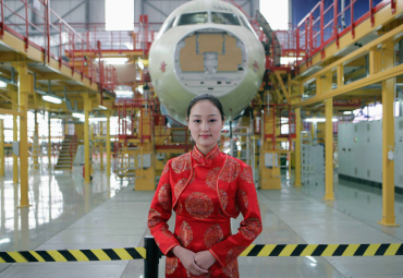 A staff member stands in front of Airbus A320 final assembly line in Tianjin Municipality.