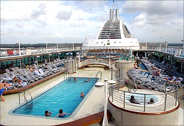 Tourists relax at the swimming pool on board a Princess Cruises liner.