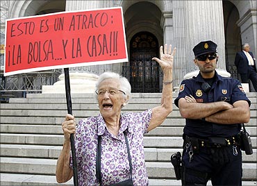 A woman shouts as she takes part in a demonstration calling for a tax on financial speculation and the abolition of tax havens.