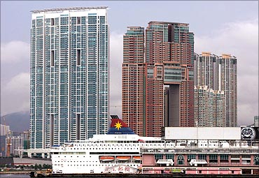 A cruise ship parks in front of two of Hong Kong's most luxurious high-rise residential buildings.