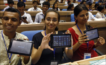 Students with the world's cheapest tablet computer in New Delhi on October 5
