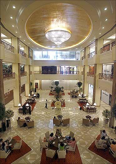 People sit inside a restaurant at the Emporio mall in New Delhi.