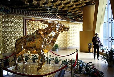 A solid gold bull weighing a tonne also greets visitors at a viewing area on the 60th-floor of the tower.