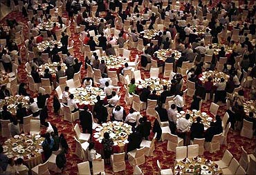 Guests attend a dinner at the new skyscraper tower of Huaxi village before its official inauguration.