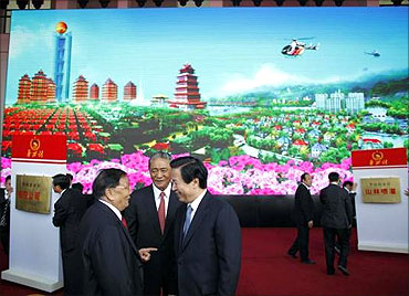 Officials attend the inauguration ceremony of the new skyscraper tower of Huaxi village.