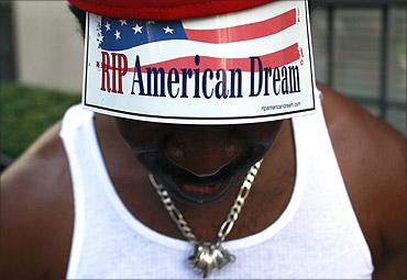 A member of the Occupy Wall Street movement shows his sign as he protests on 5th Avenue, New York.