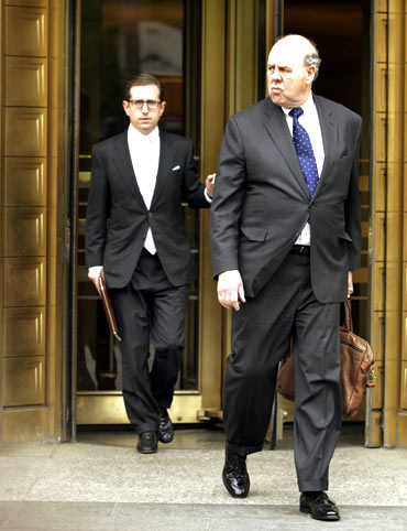 Lawyer John Dowd (R) exits Manhattan Federal Court after his client, Galleon hedge fund founder Raj Rajaratnam, was found guilty.