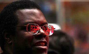 A counter showing the numbers of online support that the Occupy Wall Street movement has garnered, is reflected in the glasses of a man in New York.