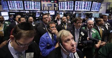 Traders work on the floor of New York Stock Exchange.