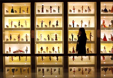 A curator walks past displays of Barbie dolls at the Doll Industry Museum in Taishan, Taipei County.