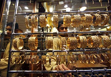 A youth arranges the jewellery in a gold shop in Mattrah Souq, the oldest market in Oman.