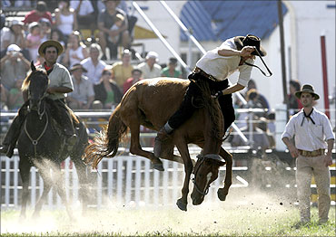 A Uruguayan gaucho rides a wild horse in Montevideo.