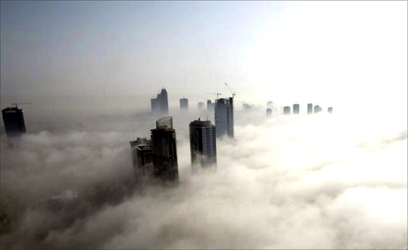 Fog rolls by early in the morning, near the Dubai Marina construction and residential zone, in Dubai.