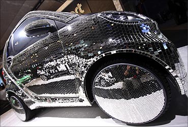 A disco-ball mirror covered Electric Drive Smart Car is seen on display at the New York International Auto Show in New York City.