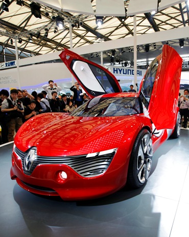Visitors look at a Renault DeZir car on the opening day of the Shanghai Auto Show.