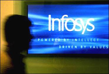 A man walks past a billboard of Infosys Technologies's office in Bangalore.