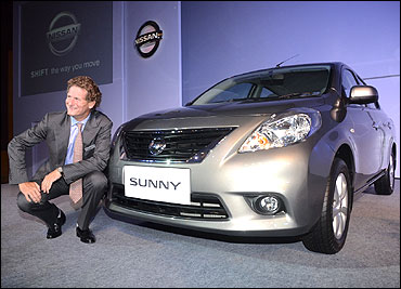Gilles Normand, corporate vice president, Africa, Middle East & India, Nissan Motor Company posing with the Nissan Sunny.
