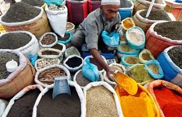 A vendor sells spices on a street in Srinagar.