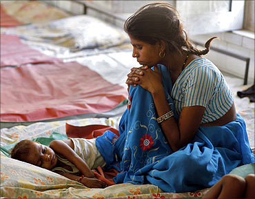 A mother looks at her malnourished child in the Nutritional Rehabilitation Centre of Sheopur district.