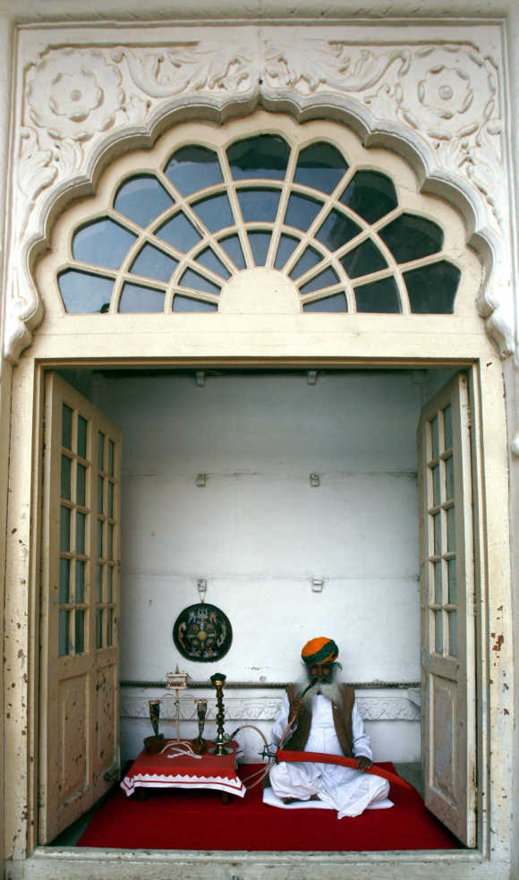 A man sits inside his shop of Hukkas at the Meharangarh Fort in Jodhpur, Rajasthan.