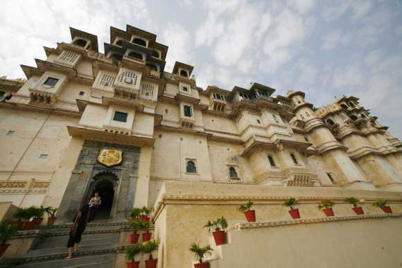 Tourists stand at the City Palace in Udaipur, Rajasthan.