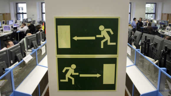 Two signs showing two different escape routes are pictured at the Frankfurt stock exchange.