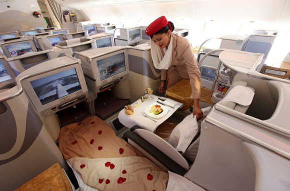 A stewardess adjusts a pillow in the business-class section of an Emirates Airbus A380 at the ILA Berlin Air Show, Germany.