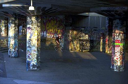 A boy rides his bike on the south bank in London.