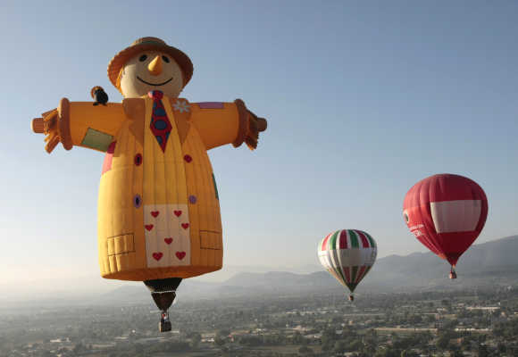 Hot air balloons float next to the Sun pyramids of Teotihuacan outside Mexico City.