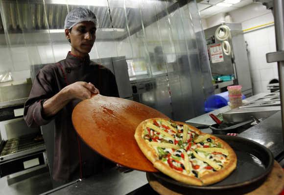 A Pizza is being made.