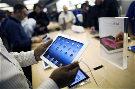 Customers look at the new iPad at the Apple Store in the Eaton Centre shopping mall in Toronto.