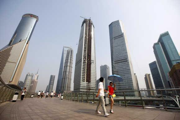 Visitors walk through the Lujiazui Financial Area in Shanghai.