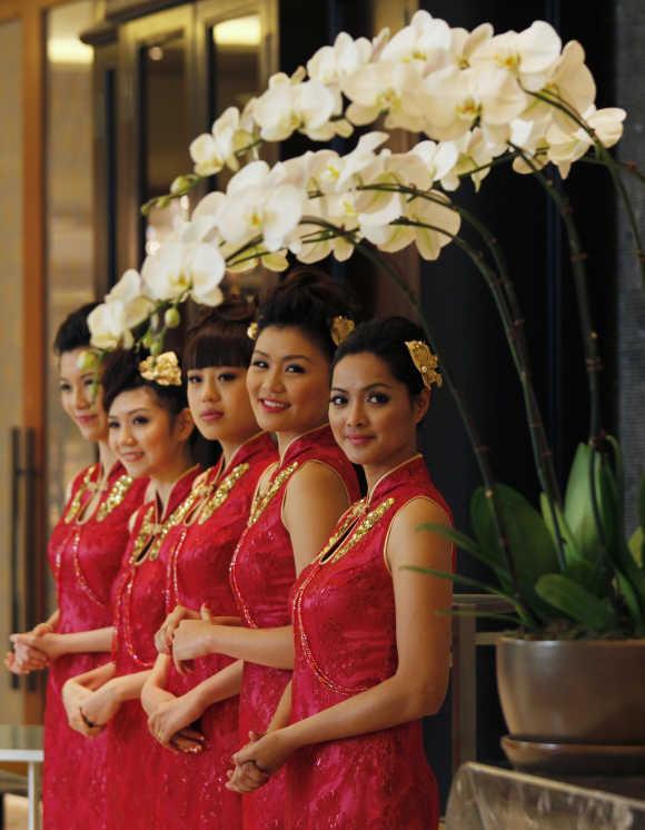 Attendants welcome guests inside Galaxy Macau during its opening.