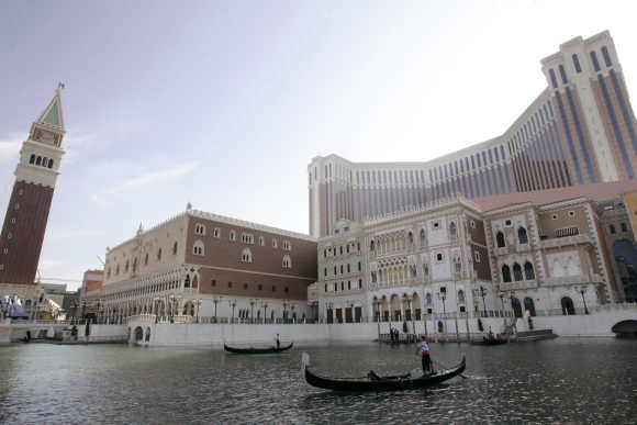 Performers steer their gondolas at the Venetian in Macau.