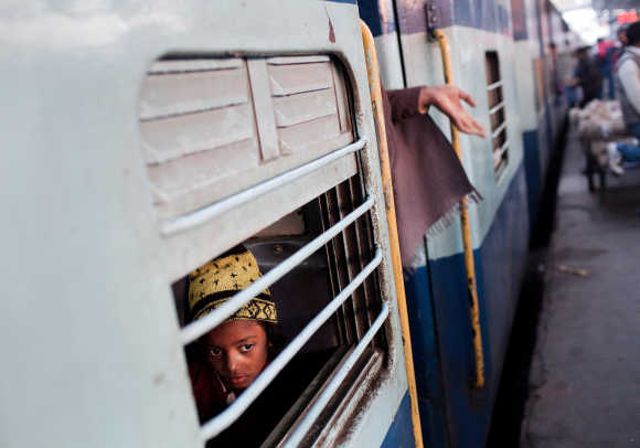 A girl peers out from a carriage at Nizamuddin Railway Station.