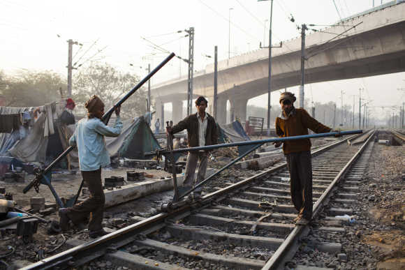 Labourers work on the tracks at Nizamuddin Railway Station.