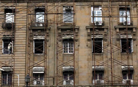 A labourer carries out renovation work on a commercial building in Mumbai. Photo is for representation purpose only.