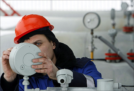 A Gazprom technician works on a pressure gauge at the gas export monopoly's Sudzha compressor station.