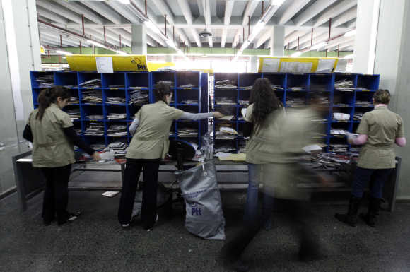 Workers sort mail and parcels in one of the Turkey's regional postal logistic centre in Ankara.