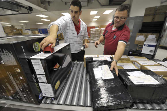 Workers deploy packages in logistic centre in Ljubljana.